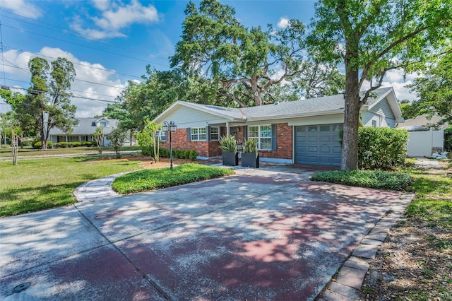 202 S Hesperides St, Tampa, FL 33609 - ranch-style home with brick siding, an attached garage, driveway, and a front lawn
