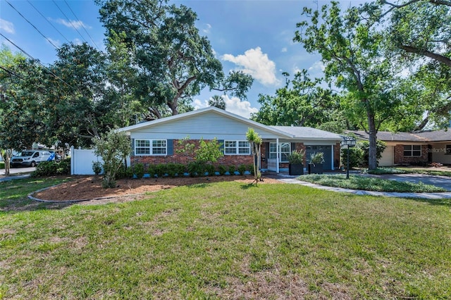 202 S Hesperides St, Tampa, FL 33609 - ranch-style home featuring brick siding, an attached garage, and a front yard