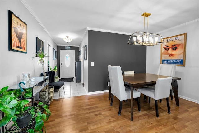 202 S Hesperides St, Tampa, FL 33609 - dining space featuring crown molding, a chandelier, and light wood finished floors
