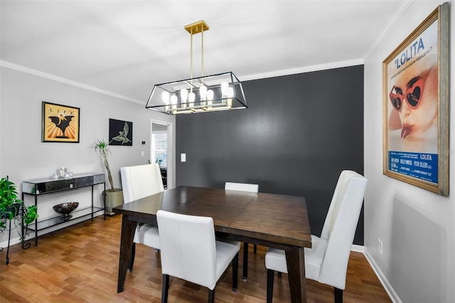 202 S Hesperides St, Tampa, FL 33609 - dining space with ornamental molding, wood finished floors, and a chandelier