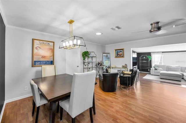 202 S Hesperides St, Tampa, FL 33609 - dining area featuring ornamental molding, wood finished floors, a chandelier, and recessed lighting