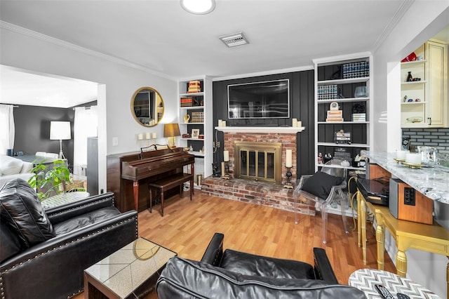 202 S Hesperides St, Tampa, FL 33609 - living area featuring ornamental molding, a brick fireplace, wood finished floors, and built in features