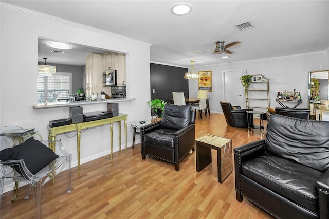 202 S Hesperides St, Tampa, FL 33609 - living area featuring light wood-type flooring, a ceiling fan, and crown molding