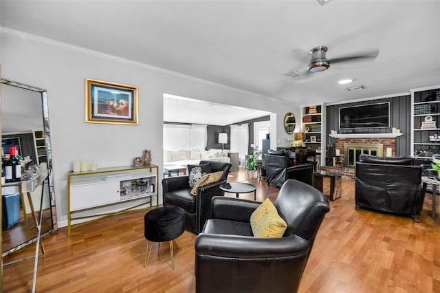 202 S Hesperides St, Tampa, FL 33609 - living area featuring ornamental molding, ceiling fan, wood finished floors, and a brick fireplace