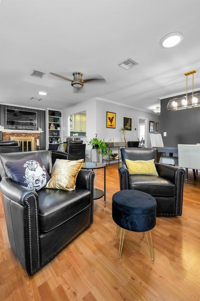 202 S Hesperides St, Tampa, FL 33609 - living area featuring light wood-style flooring, ceiling fan, ornamental molding, and built in shelves