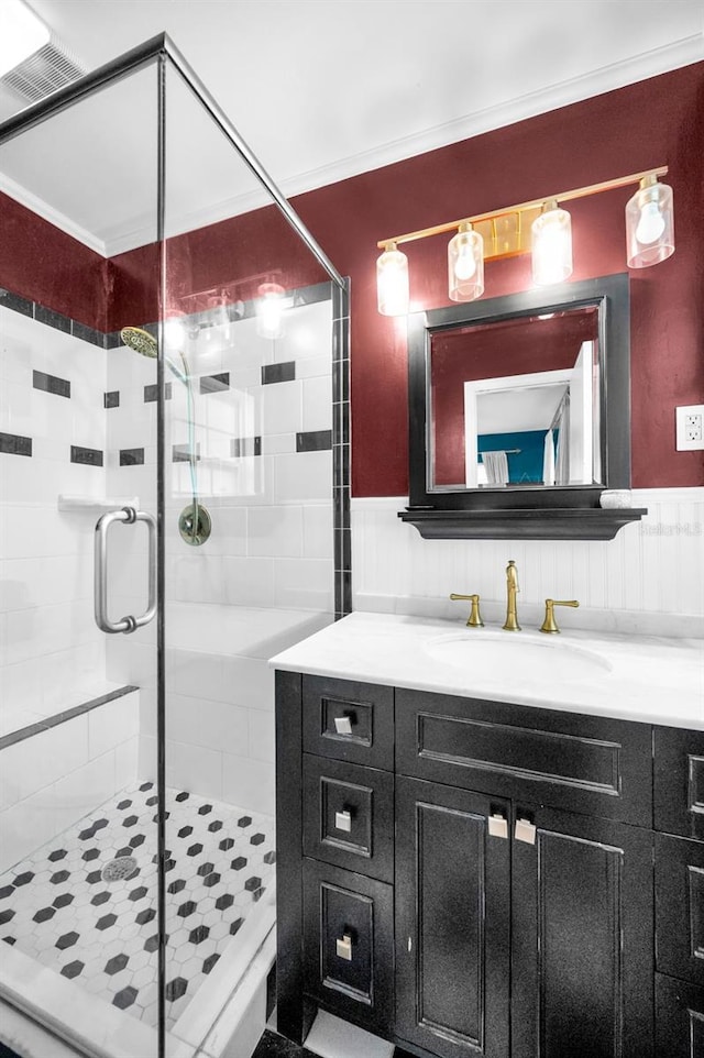 202 S Hesperides St, Tampa, FL 33609 - full bathroom with vanity, a stall shower, and wainscoting