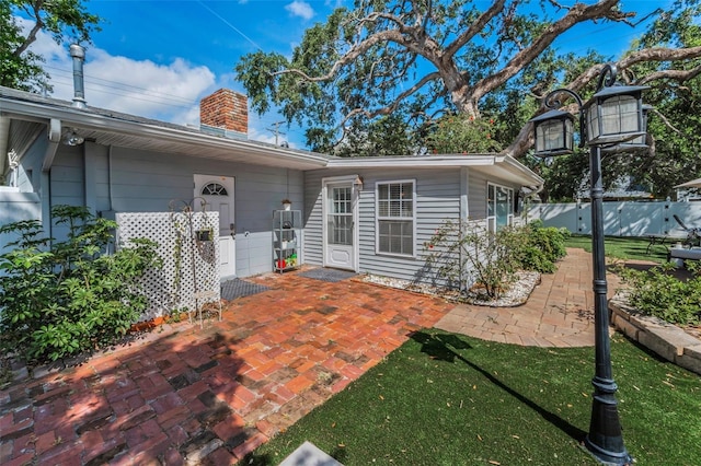 202 S Hesperides St, Tampa, FL 33609 - back of house featuring a chimney and a patio area