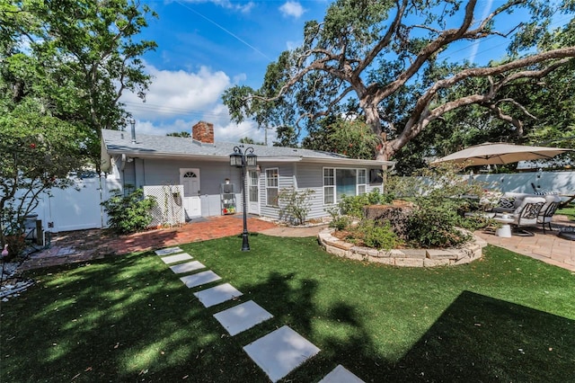 202 S Hesperides St, Tampa, FL 33609 - rear view of house featuring a chimney and a patio area