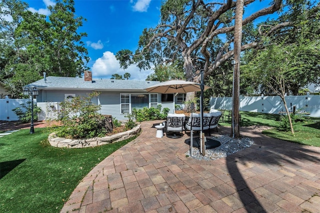 202 S Hesperides St, Tampa, FL 33609 - rear view of property featuring a patio, a chimney, and a fenced backyard