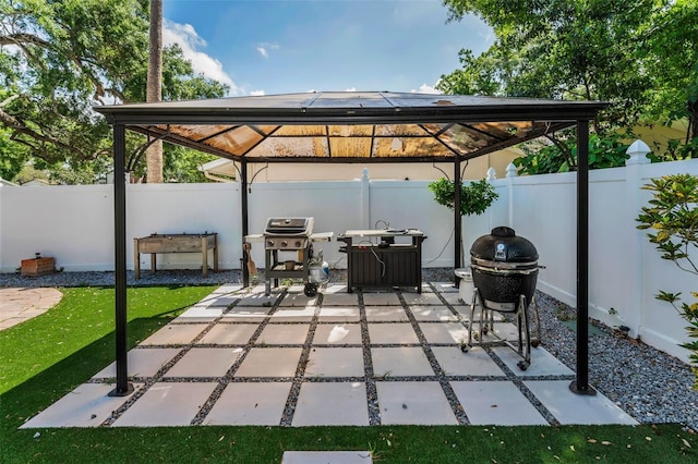 202 S Hesperides St, Tampa, FL 33609 - fenced backyard with a gazebo, area for grilling, and a patio