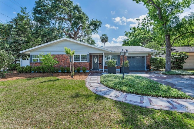 202 S Hesperides St, Tampa, FL 33609 - ranch-style home featuring brick siding, an attached garage, concrete driveway, and a front yard