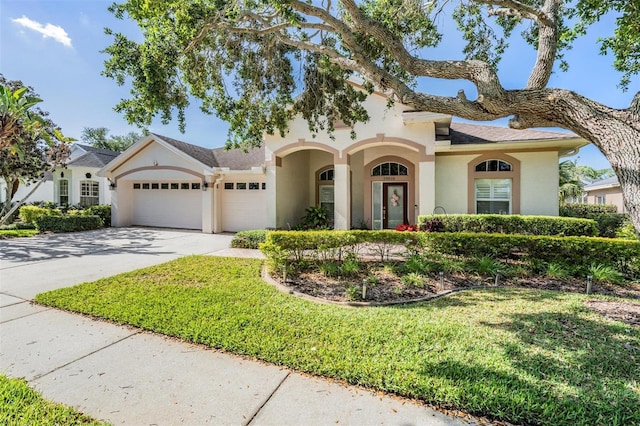 10510 Castleford Way, Tampa, FL 33626 - mediterranean / spanish house with an attached garage, stucco siding, concrete driveway, and a front yard