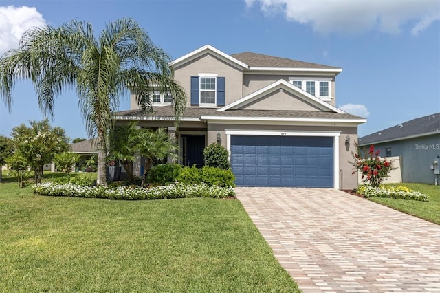 879 De Soto Blvd, Tarpon Springs, FL 34689 - traditional-style home with stucco siding, a front lawn, and decorative driveway