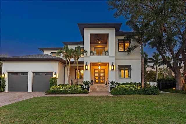 2501 S Dundee St, Tampa, FL 33629 - view of front of house with a balcony, an attached garage, stucco siding, decorative driveway, and french doors