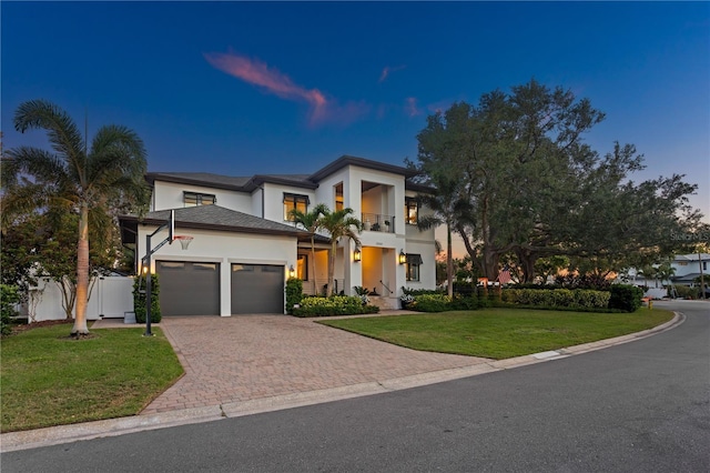 2501 S Dundee St, Tampa, FL 33629 - view of front of house with a balcony, stucco siding, a garage, and decorative driveway