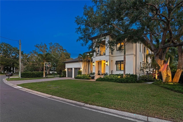 2501 S Dundee St, Tampa, FL 33629 - view of front of property with a front lawn, an attached garage, a balcony, stucco siding, and driveway
