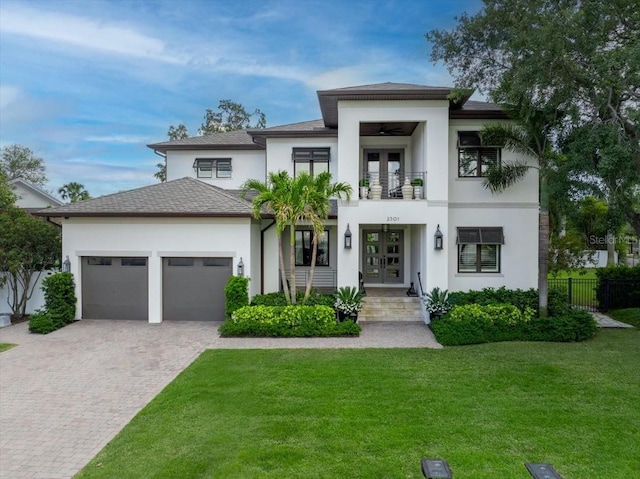 2501 S Dundee St, Tampa, FL 33629 - view of front of property featuring french doors, a balcony, stucco siding, a garage, and decorative driveway
