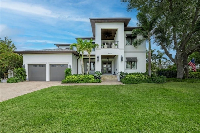 2501 S Dundee St, Tampa, FL 33629 - contemporary house with a balcony, french doors, stucco siding, a front lawn, and a garage