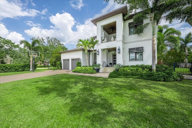 2501 S Dundee St, Tampa, FL 33629 - contemporary home featuring a balcony, driveway, stucco siding, an attached garage, and ceiling fan
