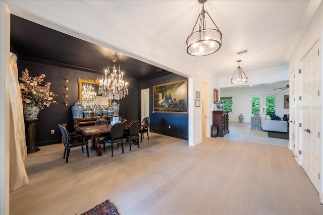 2501 S Dundee St, Tampa, FL 33629 - dining space featuring a chandelier, wood finished floors, ornamental molding, baseboards, and french doors