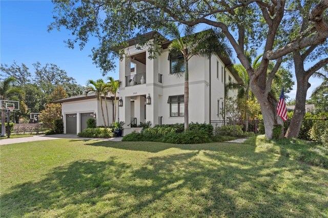 2501 S Dundee St, Tampa, FL 33629 - view of front of property with a balcony, stucco siding, driveway, and a garage