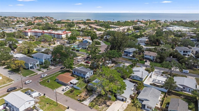 drone / aerial view with a water view and a residential view