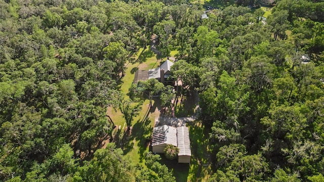birds eye view of property with a view of trees