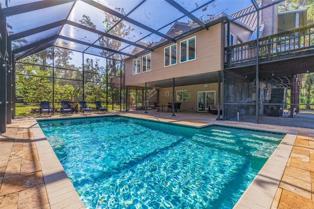 pool featuring a patio area and glass enclosure