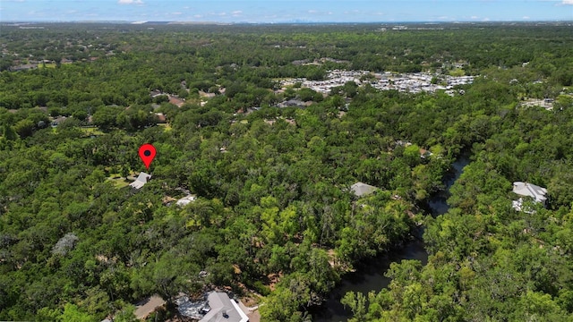 drone / aerial view featuring a wooded view