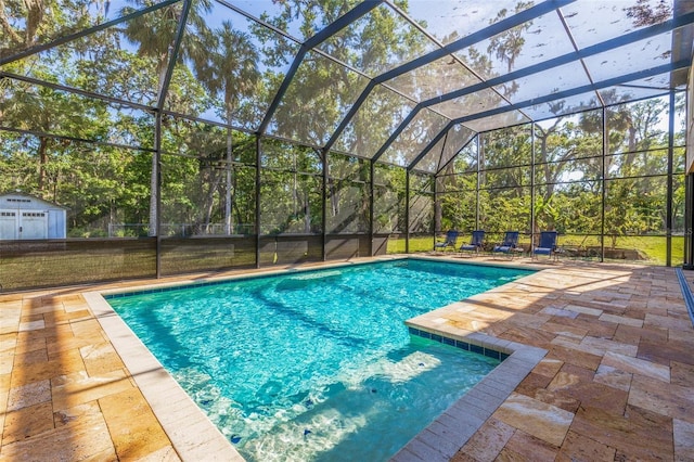 outdoor pool with a patio area and glass enclosure