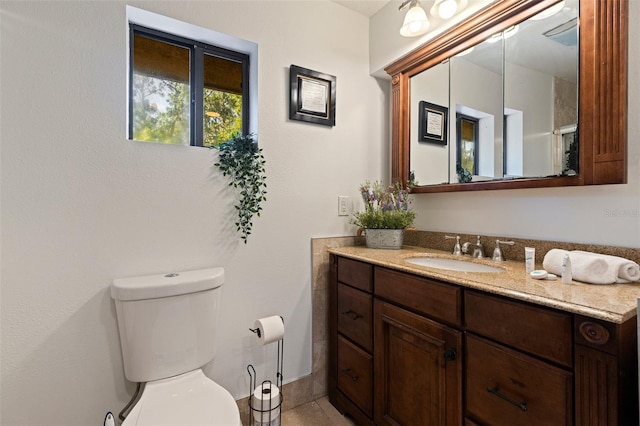 bathroom featuring toilet and vanity