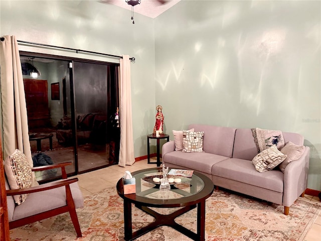 living area with light tile patterned floors and baseboards