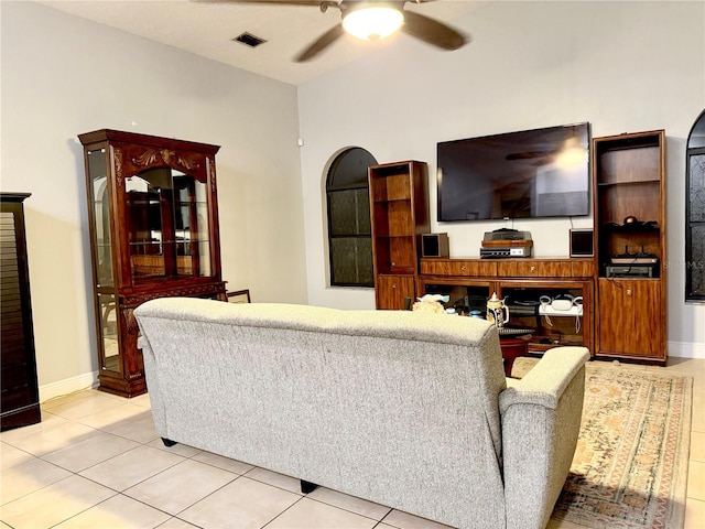 living area with visible vents, baseboards, a ceiling fan, and light tile patterned floors