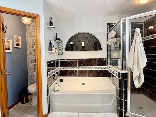 bathroom with a textured ceiling, toilet, a shower stall, and a garden tub