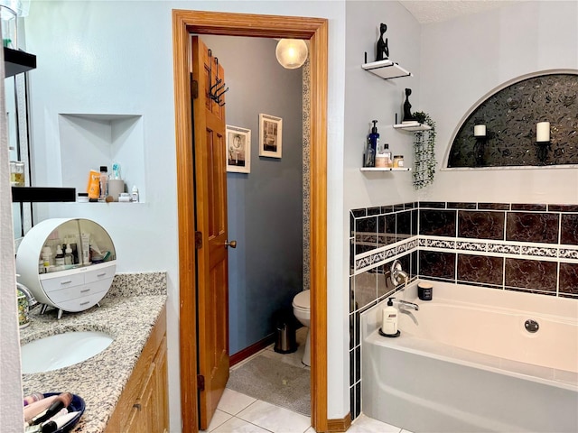 full bath featuring tile patterned floors, vanity, a garden tub, and toilet