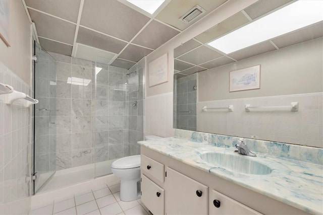 full bath featuring vanity, tile patterned flooring, toilet, a shower stall, and visible vents
