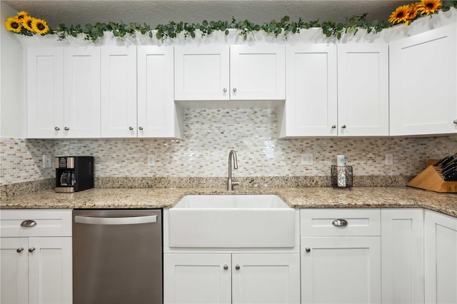 kitchen with dishwasher, a sink, backsplash, and white cabinets
