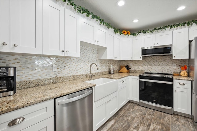 kitchen featuring white cabinets, a sink, and appliances with stainless steel finishes