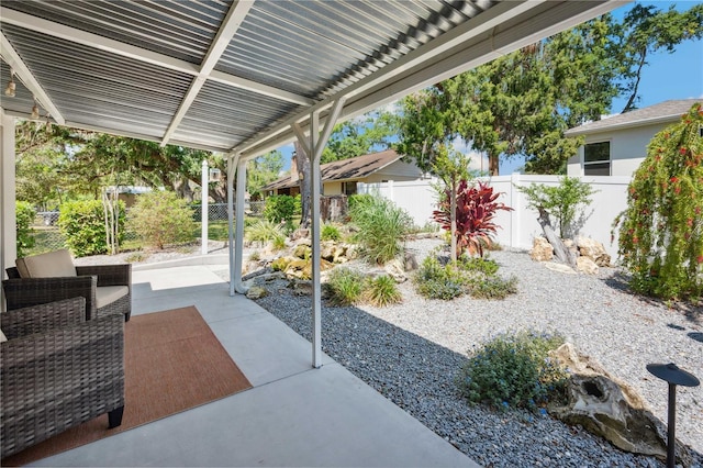 view of patio featuring a pergola and fence