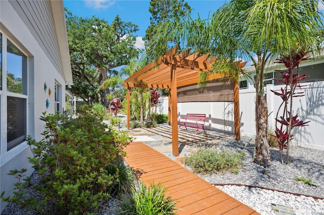deck featuring a patio, a pergola, and fence