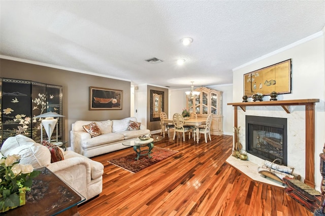 11383 Pickford St, Spring Hill, FL 34609 - living area featuring crown molding, visible vents, wood finished floors, a textured ceiling, and a premium fireplace
