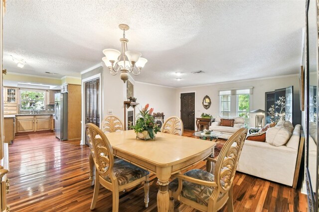 11383 Pickford St, Spring Hill, FL 34609 - dining room with a healthy amount of sunlight, dark wood-style floors, and a textured ceiling