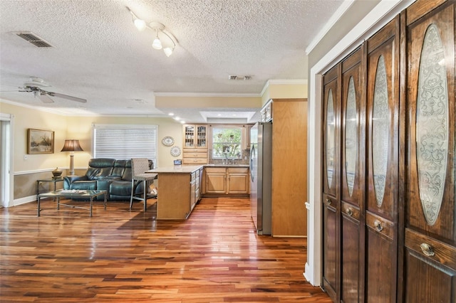 11383 Pickford St, Spring Hill, FL 34609 - kitchen with ornamental molding, freestanding refrigerator, wood finished floors, and open floor plan