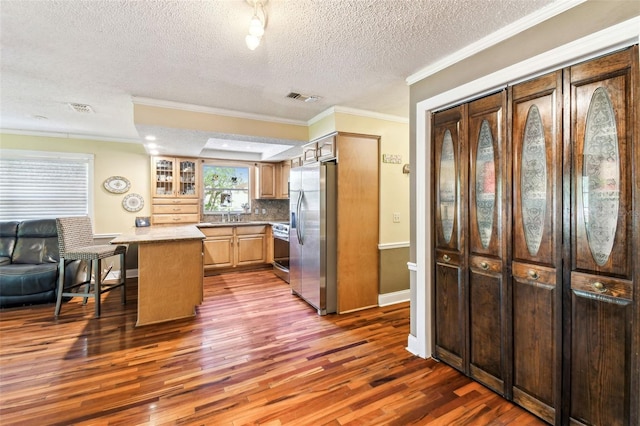 11383 Pickford St, Spring Hill, FL 34609 - kitchen featuring ornamental molding, baseboards, dark wood-style floors, a textured ceiling, and appliances with stainless steel finishes
