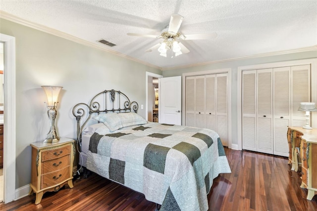11383 Pickford St, Spring Hill, FL 34609 - bedroom with visible vents, crown molding, multiple closets, dark wood-style floors, and a textured ceiling