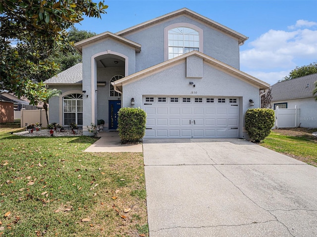 1830 Citrus Orchard Way, Valrico, FL 33594 - traditional-style home featuring a garage, stucco siding, fence, a front yard, and driveway