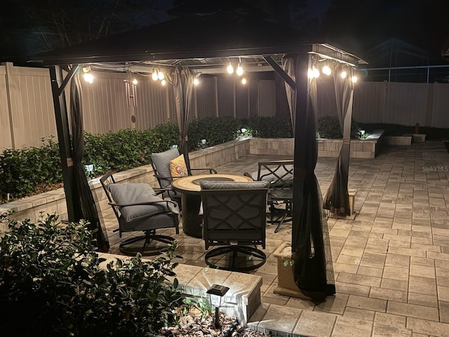 1830 Citrus Orchard Way, Valrico, FL 33594 - patio at night featuring a fire pit and fence