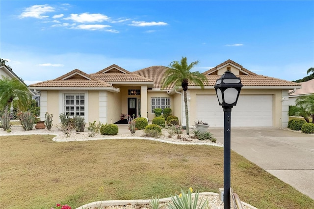 single story home featuring concrete driveway, stucco siding, an attached garage, and a tile roof
