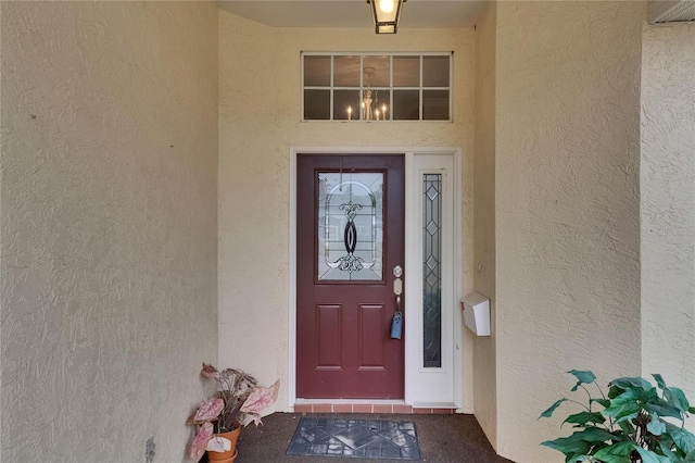 entrance to property with stucco siding