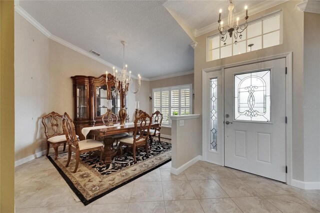 foyer entrance featuring visible vents, baseboards, a notable chandelier, a textured ceiling, and crown molding